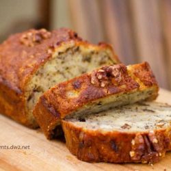 Bourbon banana bread sliced on a wooden cutting board