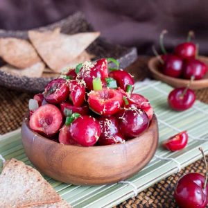 Fresh cherry salsa in a wooden bowl