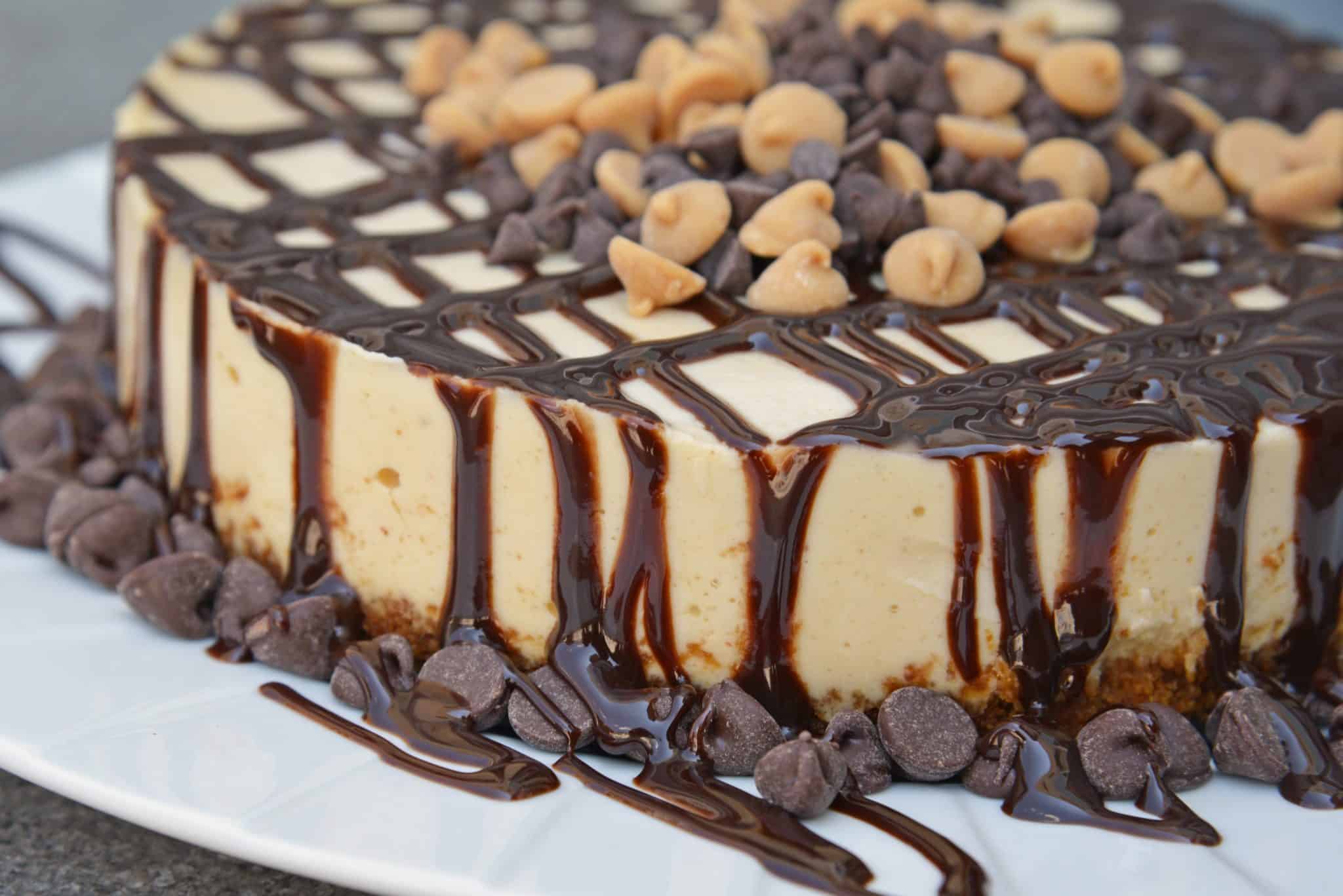 Instant Pot Peanut Butter Cheesecake is a rich and creamy cheesecake with a graham cracker crust, layer of chocolate and topped with peanut butter and chocolate chips. #instantpotcheesecake #peanutbuttercheesecake www.savoryexperiments.com 