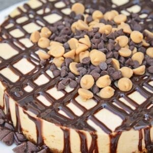 Instant Pot Peanut Butter Cheesecake is a rich and creamy cheesecake with a graham cracker crust, layer of chocolate and topped with peanut butter and chocolate chips. #instantpotcheesecake #peanutbuttercheesecake www.savoryexperiments.com