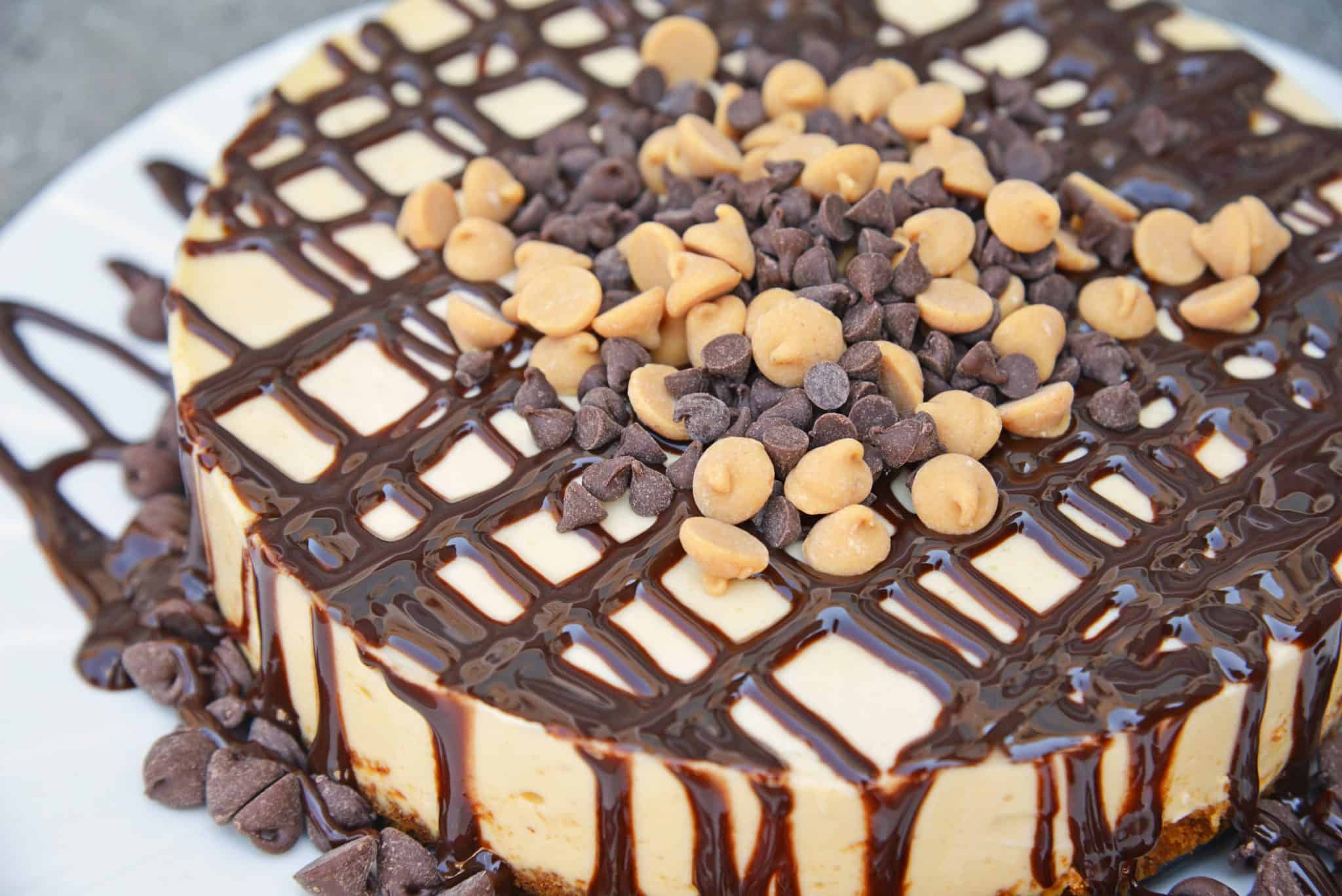 Instant Pot Peanut Butter Cheesecake is a rich and creamy cheesecake with a graham cracker crust, layer of chocolate and topped with peanut butter and chocolate chips. #instantpotcheesecake #peanutbuttercheesecake www.savoryexperiments.com