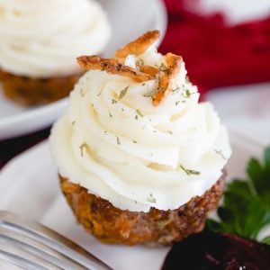 close up of a meatloaf muffin with mashed potatoes on top