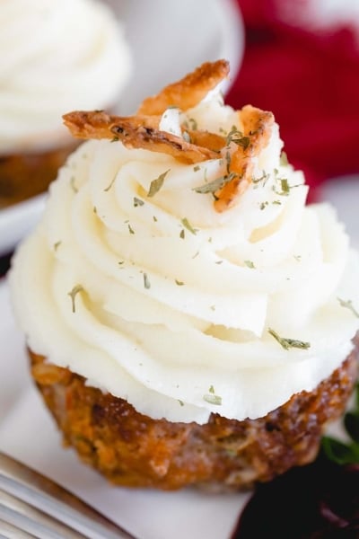 close up of a meatloaf muffin with mashed potatoes on top