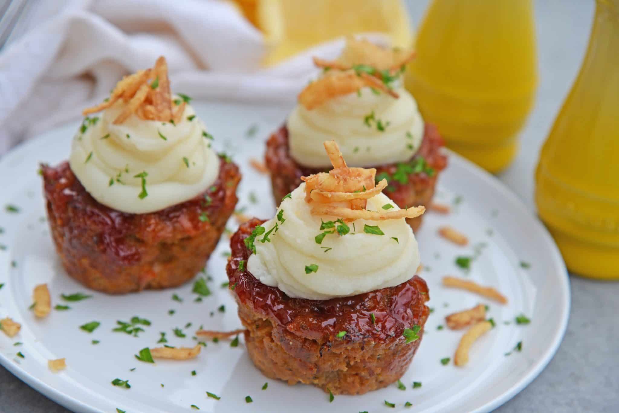 Three meatloaf muffins on a white plate