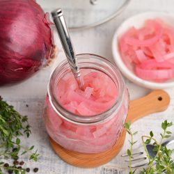 overview angle of pickled red onion in a small glass jar