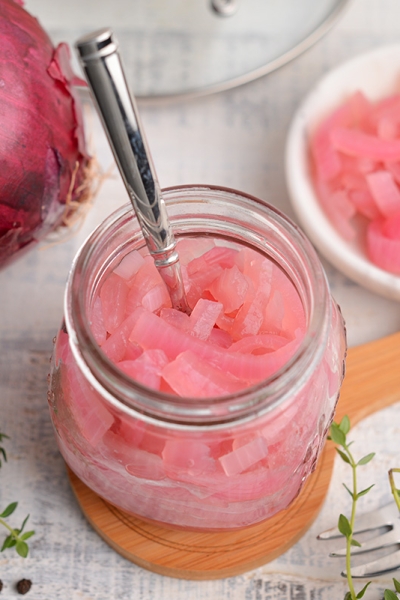 overview angle of pickled red onion in a small glass jar