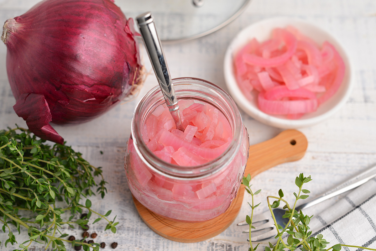 overview angle of pickled red onion in a small glass jar