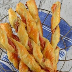 Prosciutto Parmesan Cheese Straws are made with just a few ingredients and 10 minutes in the oven! An easy appetizer for all occasions. #cheesestraws #puffpastrybreadsticks www.savoryexperiments.com