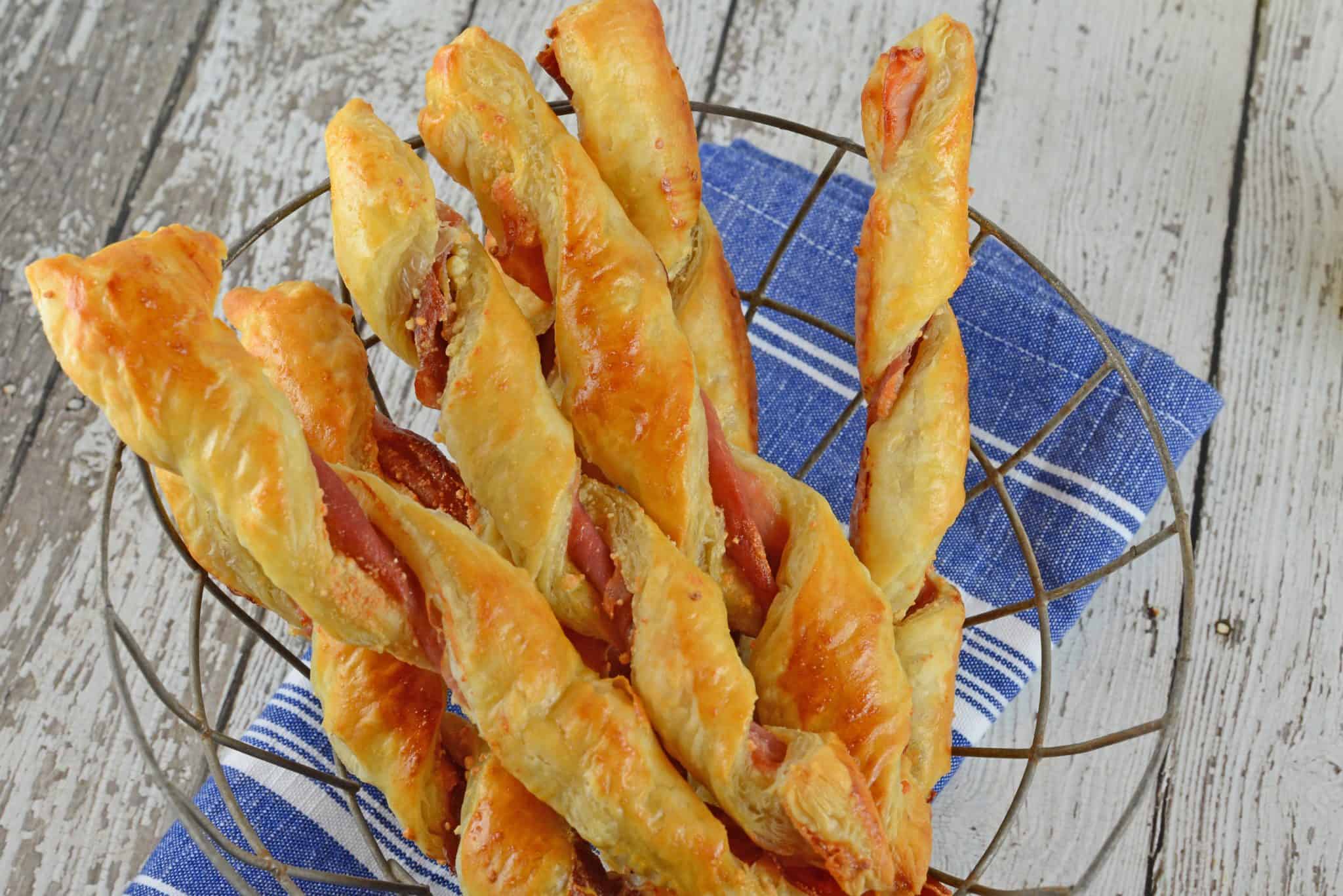 Prosciutto Parmesan Cheese Straws are made with just a few ingredients and 10 minutes in the oven! An easy appetizer for all occasions. #cheesestraws #puffpastrybreadsticks www.savoryexperiments.com