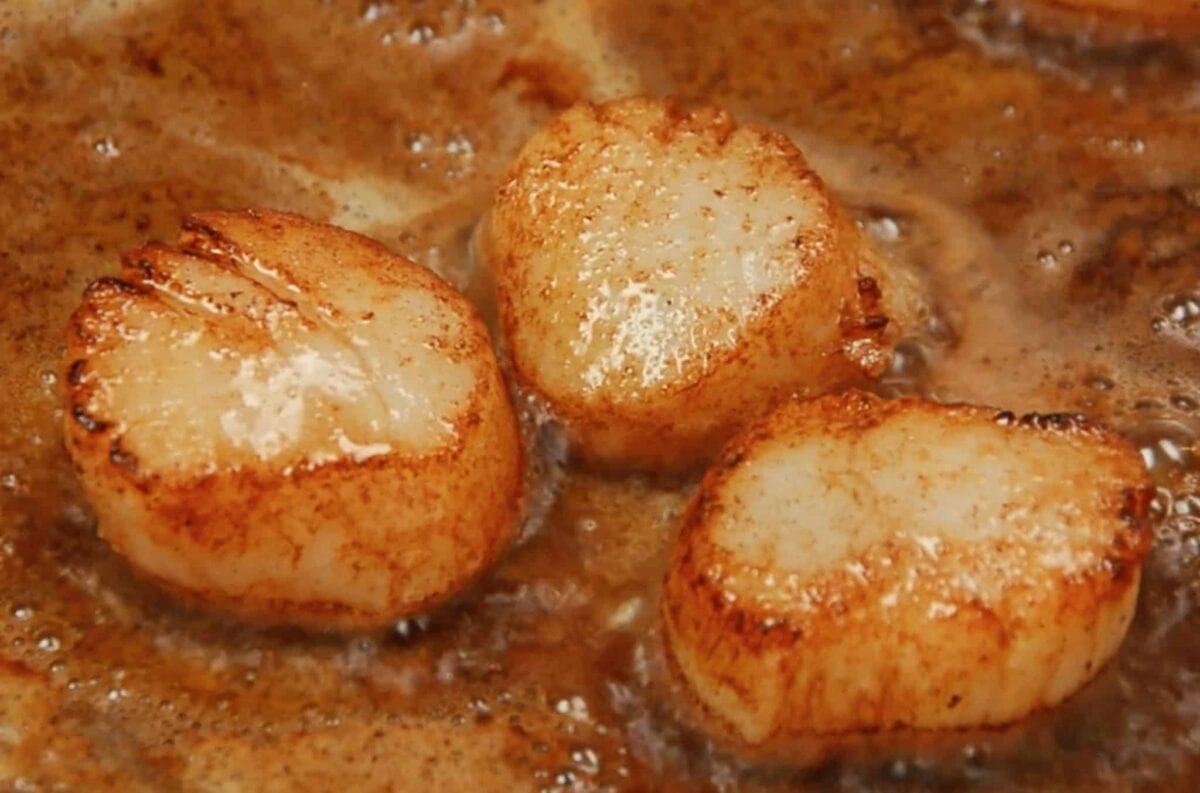 Pan Seared Scallops simmering in a pan