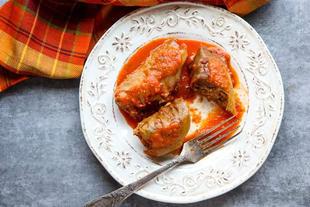 Two cabbage rolls on a white plate