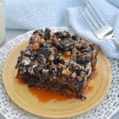 The Ultimate Slutty Brownies are layers of chocolate chip cookie dough, brownie, Oreo cookies, caramel and sea salt. The perfect decadent, sweet and salty easy dessert recipe. #sluttybrownies #bestbrownierecipe www.savoryexperiments.com