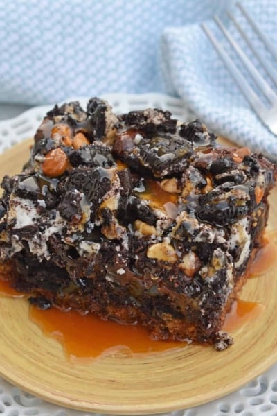 The Ultimate Slutty Brownies are layers of chocolate chip cookie dough, brownie, Oreo cookies, caramel and sea salt. The perfect decadent, sweet and salty easy dessert recipe. #sluttybrownies #bestbrownierecipe www.savoryexperiments.com