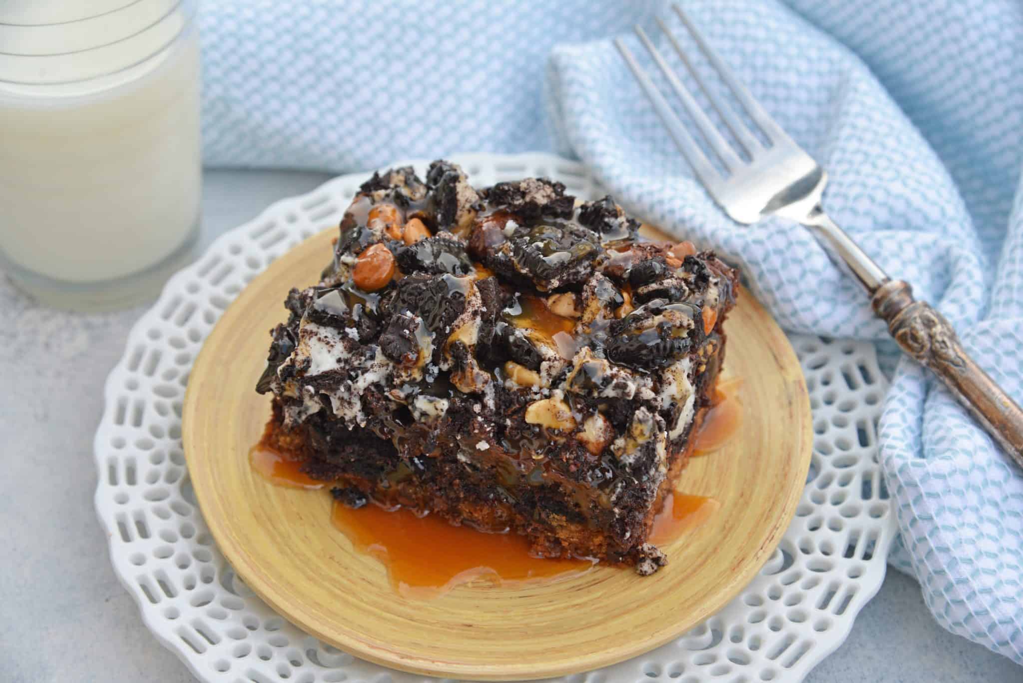 The Ultimate Slutty Brownies are layers of chocolate chip cookie dough, brownie, Oreo cookies, caramel and sea salt. The perfect decadent, sweet and salty easy dessert recipe. #sluttybrownies #bestbrownierecipe www.savoryexperiments.com