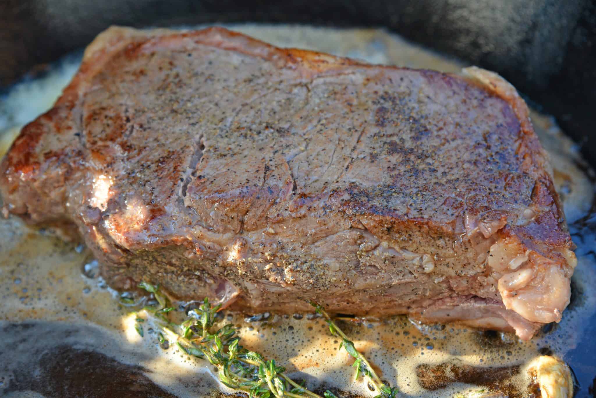 Sous Vide Steak au Poivre is a sous-vide steak recipe worthy of a random weeknight or a special occasion. New York strip is cooked to your perfect temperture smothered in a creamy Au Poivre Peppercorn Sauce. #sousvidesteak #steakaupoirve www.savoryexperiments.com 