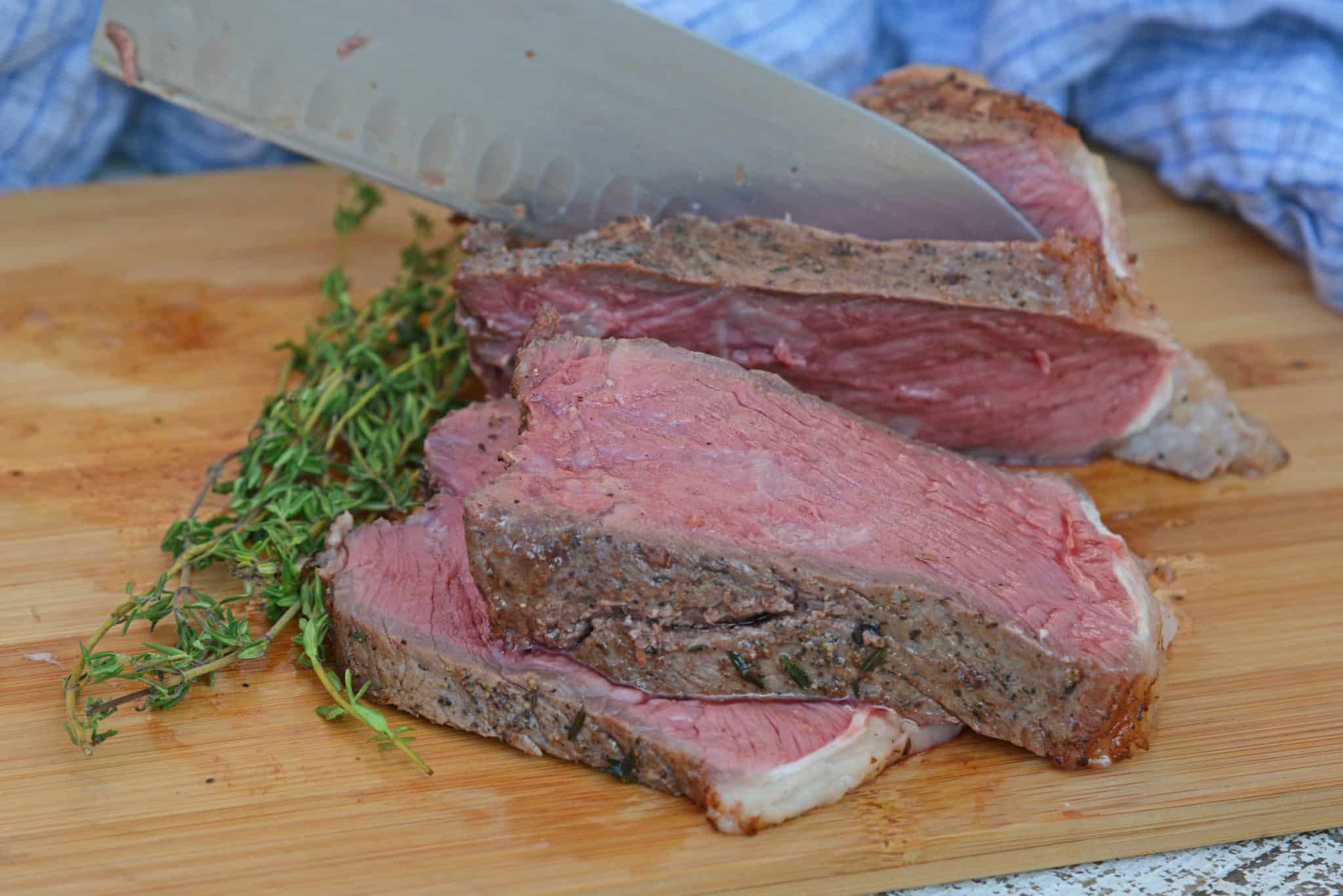 Sous Vide Steak au Poivre is a sous-vide steak recipe worthy of a random weeknight or a special occasion. New York strip is cooked to your perfect temperture smothered in a creamy Au Poivre Peppercorn Sauce. #sousvidesteak #steakaupoirve www.savoryexperiments.com 