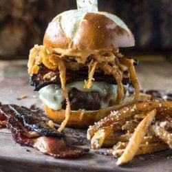 Spicy candied bacon burger with a knife through it