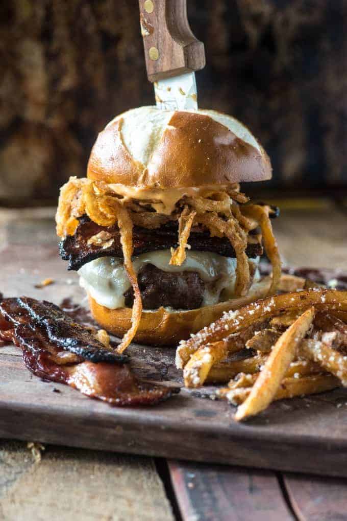 Spicy candied bacon burger with a knife through it