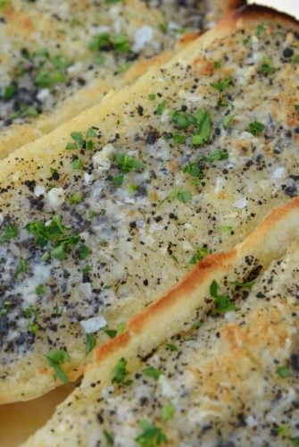 This Truffle Butter Garlic Bread is unlike any homemade garlic bread you've tasted. So delicious and made with just 3 ingredients! #trufflebutter #homemadegarlicbread www.savoryexperiments.com