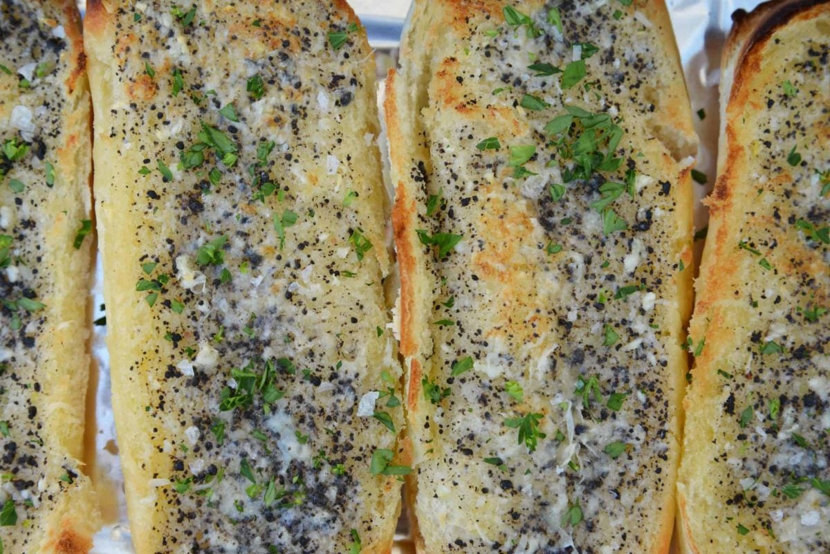 This Truffle Butter Garlic Bread is unlike any homemade garlic bread you've tasted. So delicious and made with just 3 ingredients! #trufflebutter #homemadegarlicbread www.savoryexperiments.com