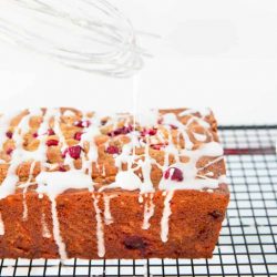 White chocolate cranberry banana bread with an icing drizzle