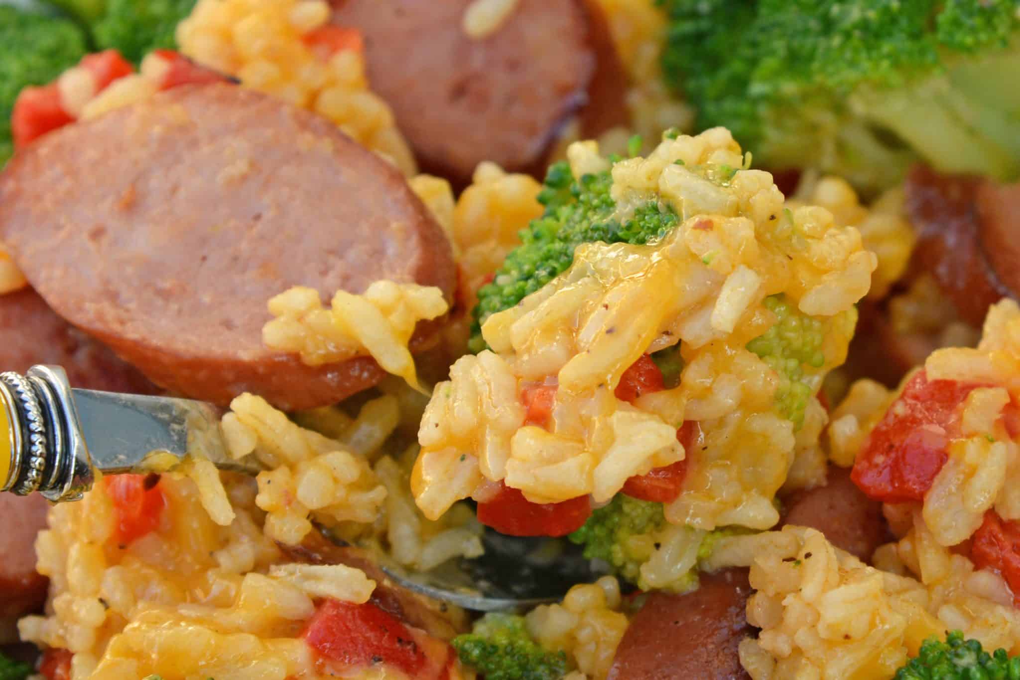 Sharp cheddar cheese tossed with rice, broccoli florets, roasted red pepper and tender Eckrich Smoked Sausage. Dinner is ready in just 15 minutes! #easydinnerideas #skilletmeals #onepandinner www.savoryexperiments.com 