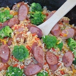 Sharp cheddar cheese tossed with rice, broccoli florets, roasted red pepper and tender Eckrich Smoked Sausage. Dinner is ready in just 15 minutes! #easydinnerideas #skilletmeals #onepandinner www.savoryexperiments.com