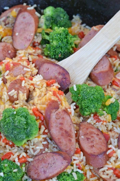 Sharp cheddar cheese tossed with rice, broccoli florets, roasted red pepper and tender Eckrich Smoked Sausage. Dinner is ready in just 15 minutes! #easydinnerideas #skilletmeals #onepandinner www.savoryexperiments.com