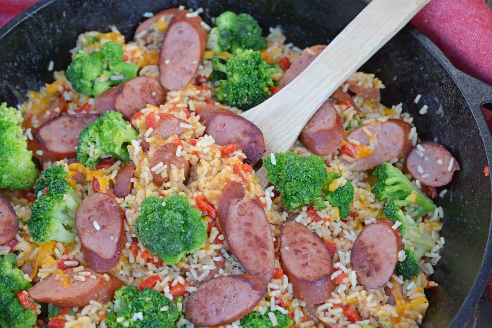 Sharp cheddar cheese tossed with rice, broccoli florets, roasted red pepper and tender Eckrich Smoked Sausage. Dinner is ready in just 15 minutes! #easydinnerideas #skilletmeals #onepandinner www.savoryexperiments.com