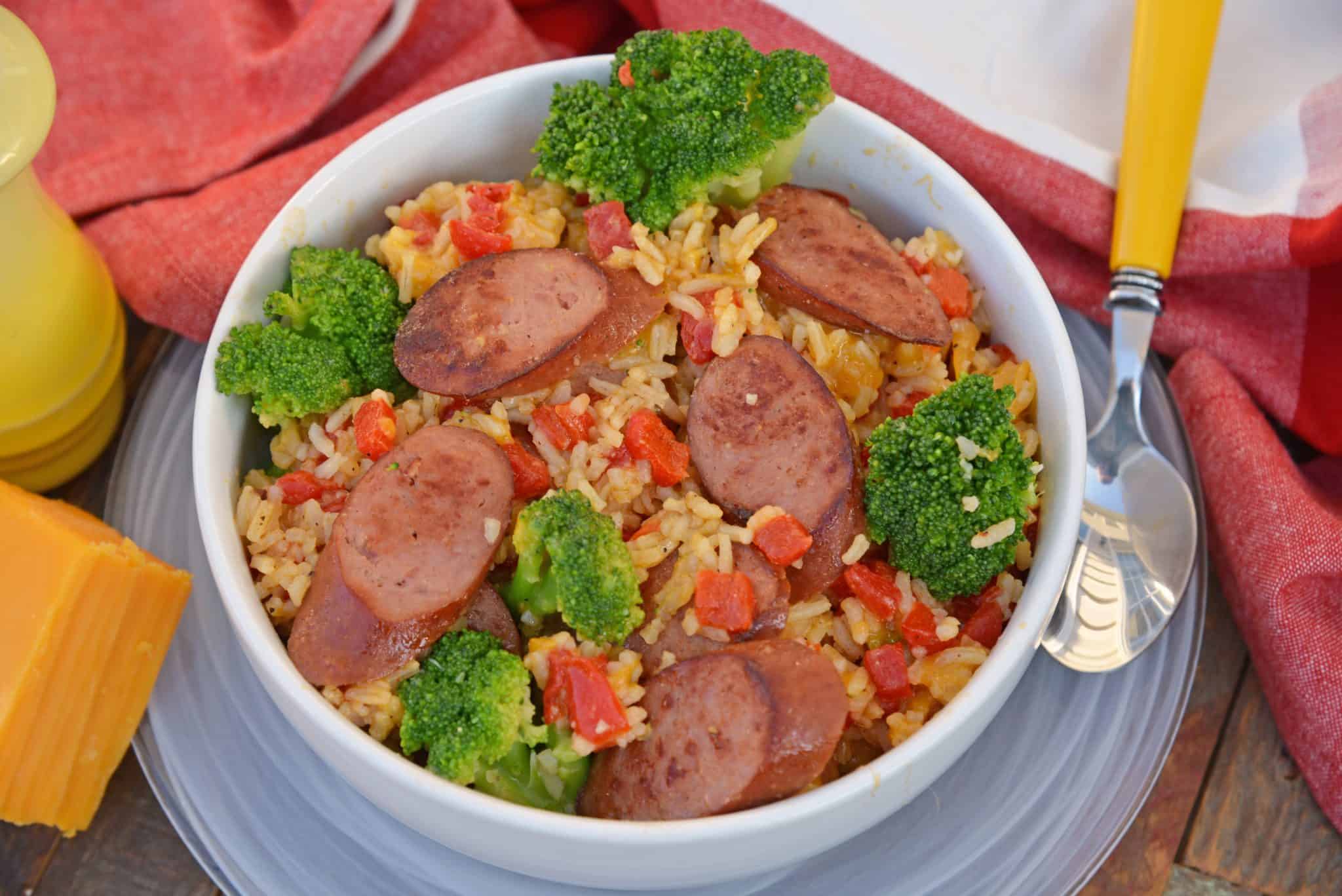 Sharp cheddar cheese tossed with rice, broccoli florets, roasted red pepper and tender Eckrich Smoked Sausage. Dinner is ready in just 15 minutes! #easydinnerideas #skilletmeals #onepandinner www.savoryexperiments.com 