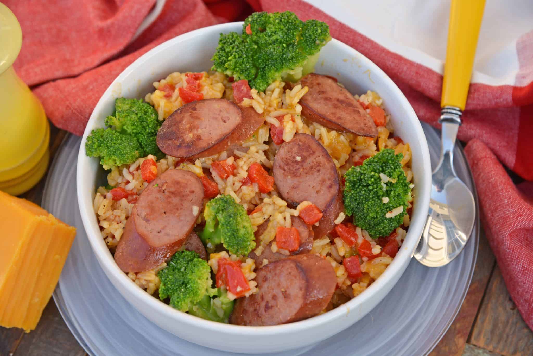 Sharp cheddar cheese tossed with rice, broccoli florets, roasted red pepper and tender Eckrich Smoked Sausage. Dinner is ready in just 15 minutes! #easydinnerideas #skilletmeals #onepandinner www.savoryexperiments.com