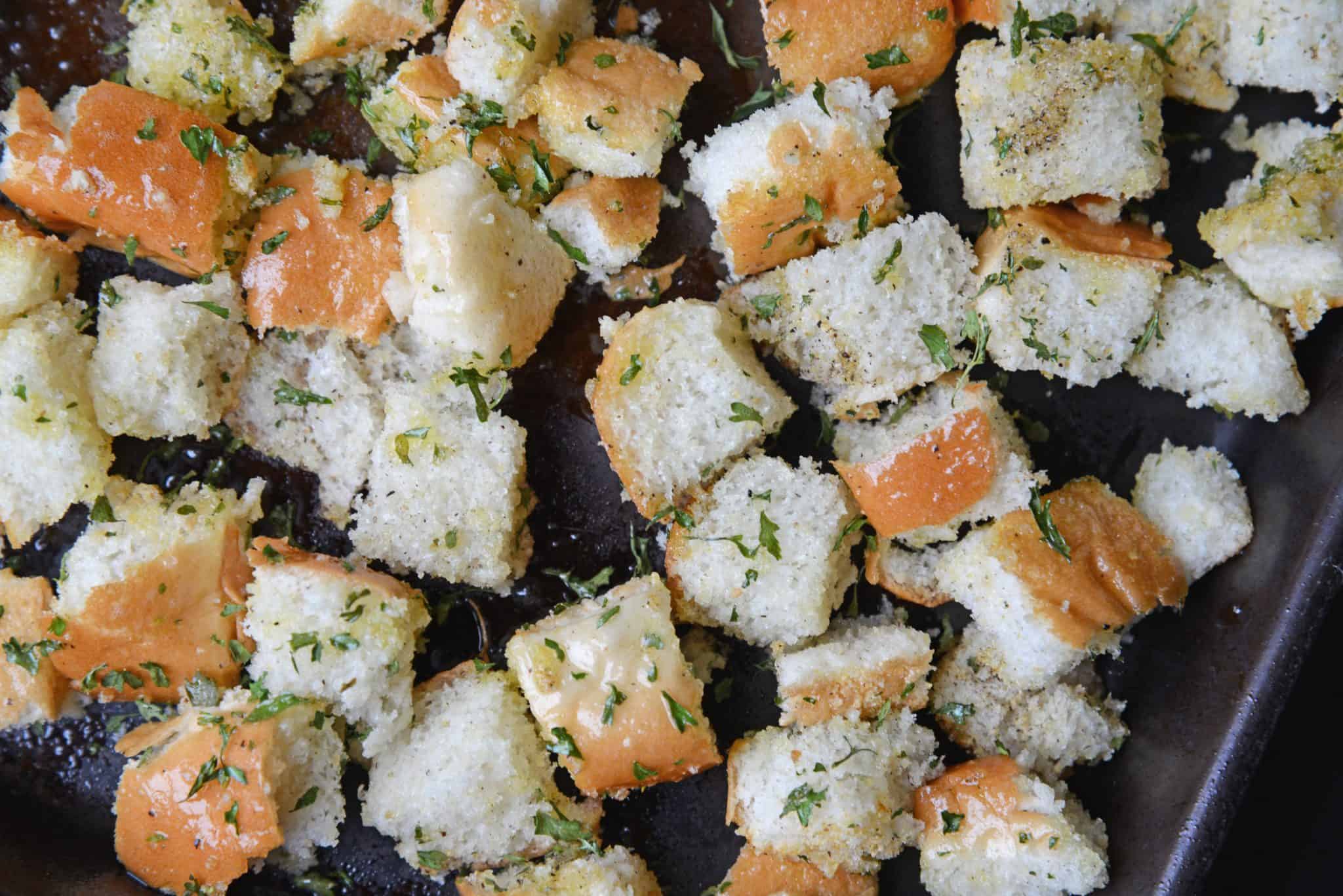 Hot Dog Bun Homemade Croutons with garlic, salt and parsley are the best for salads, soup and more! Learn how to make croutons easily with this crouton recipe. #homemadecroutons #croutonrecipe #howtomakecroutons www.savoryexperiments.com