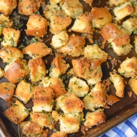 Hot Dog Bun Homemade Croutons with garlic, salt and parsley are the best for salads, soup and more! Learn how to make croutons easily with this crouton recipe. #homemadecroutons #croutonrecipe #howtomakecroutons www.savoryexperiments.com