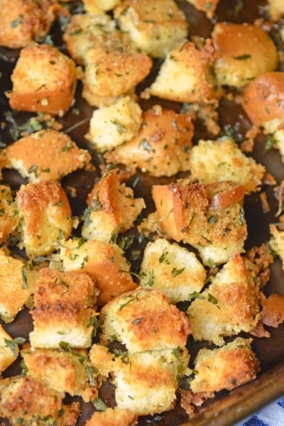 Hot Dog Bun Homemade Croutons with garlic, salt and parsley are the best for salads, soup and more! Learn how to make croutons easily with this crouton recipe. #homemadecroutons #croutonrecipe #howtomakecroutons www.savoryexperiments.com