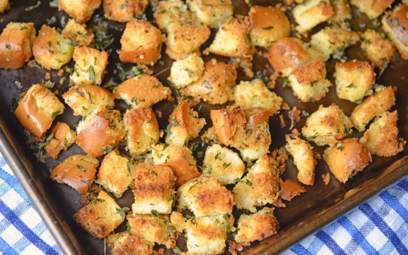 Hot Dog Bun Homemade Croutons with garlic, salt and parsley are the best for salads, soup and more! Learn how to make croutons easily with this crouton recipe. #homemadecroutons #croutonrecipe #howtomakecroutons www.savoryexperiments.com