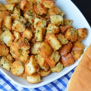 Hot Dog Bun Homemade Croutons with garlic, salt and parsley are the best for salads, soup and more! Learn how to make croutons easily with this crouton recipe. #homemadecroutons #croutonrecipe #howtomakecroutons www.savoryexperiments.com