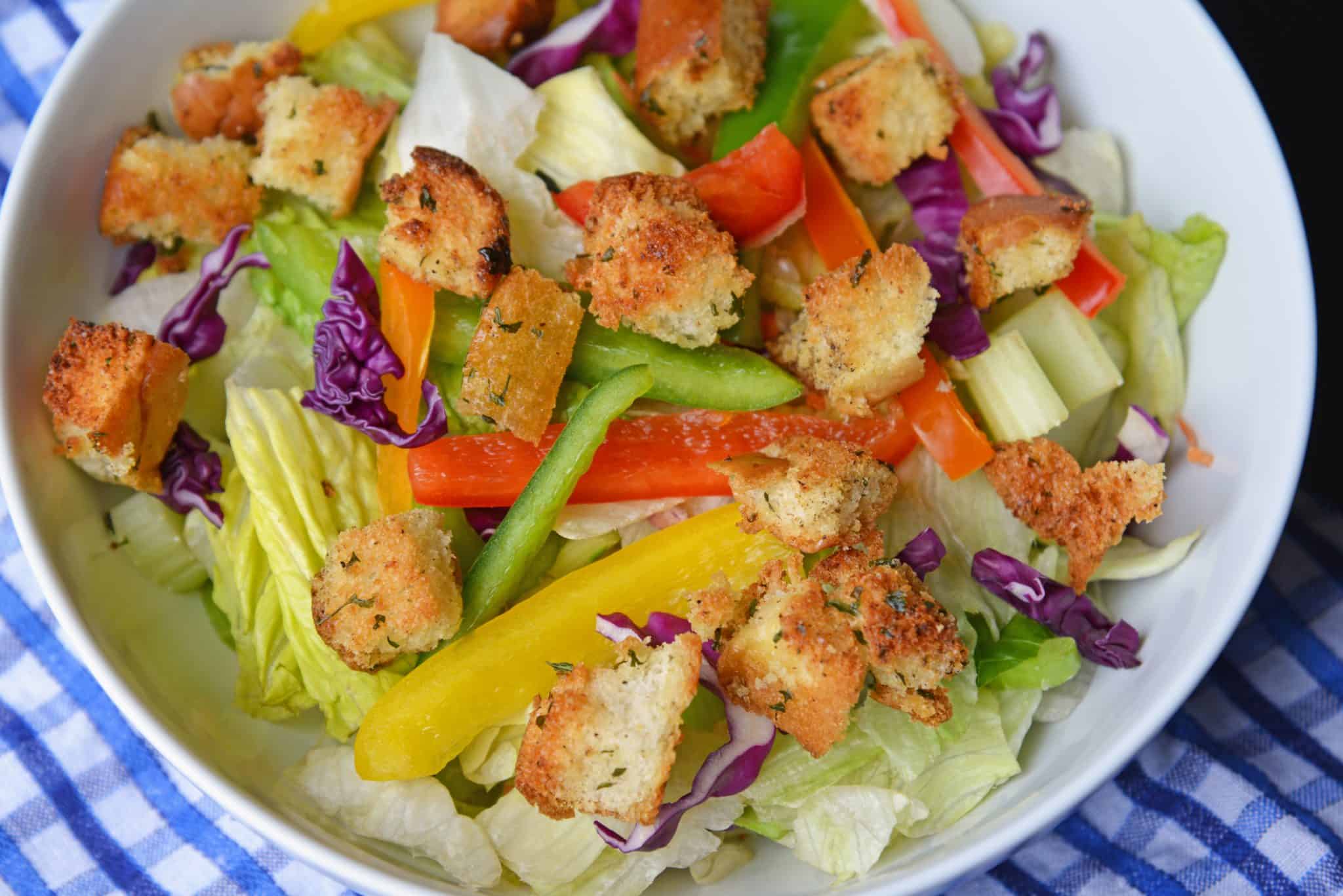 Hot Dog Bun Homemade Croutons with garlic, salt and parsley are the best for salads, soup and more! Learn how to make croutons easily with this crouton recipe. #homemadecroutons #croutonrecipe #howtomakecroutons www.savoryexperiments.com 