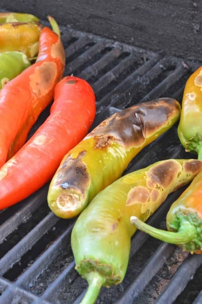 Step-by-step instructions with pictures on how to roast Hatch chile peppers. Roast, peel and seed super easy! #howtoroasthatchchilepeppers #hatchchile www.savoryexperiments.com