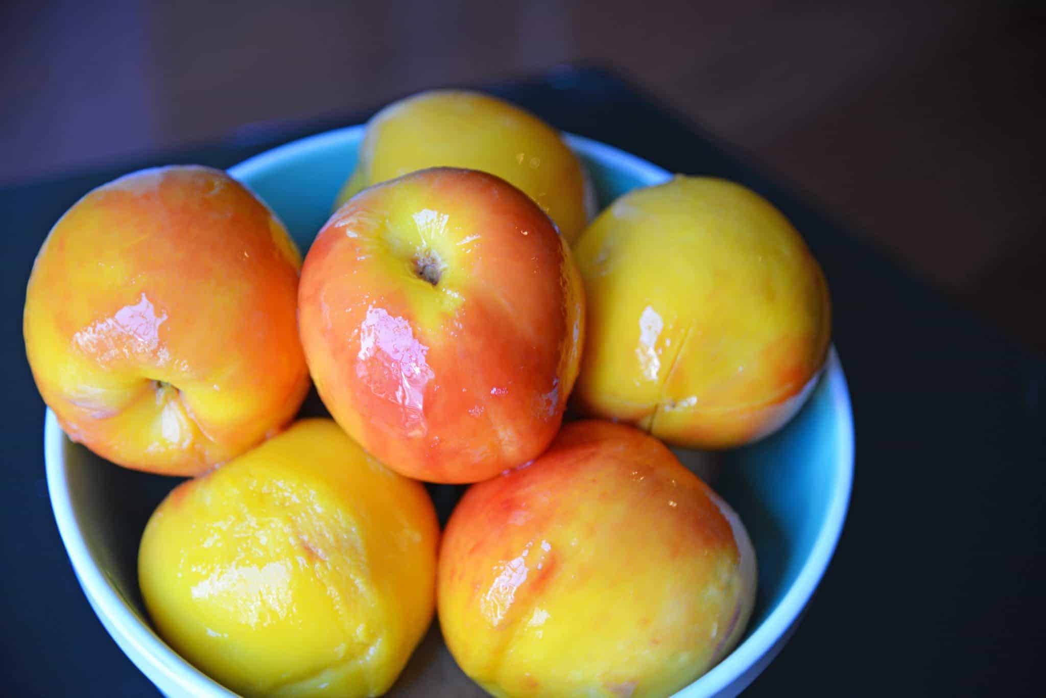 Blue bowl full of peaches