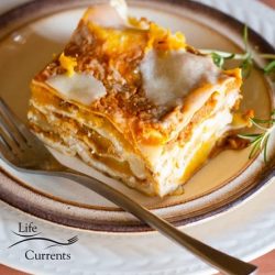 A slice of pumpkin lasagna on a plate with a fork