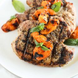 Apricot pork chops on a white plate