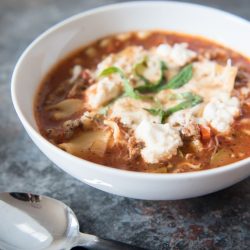 Lasagna soup in a white bowl with a spoon