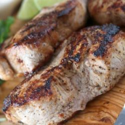 Lime cilantro pork chop on a cutting board