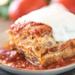 One slice of million dollar lasagna on a white plate