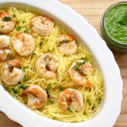 Shrimp pesto spaghetti squash in a white dish