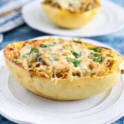 Spinach artichoke spaghetti squash on a white plate