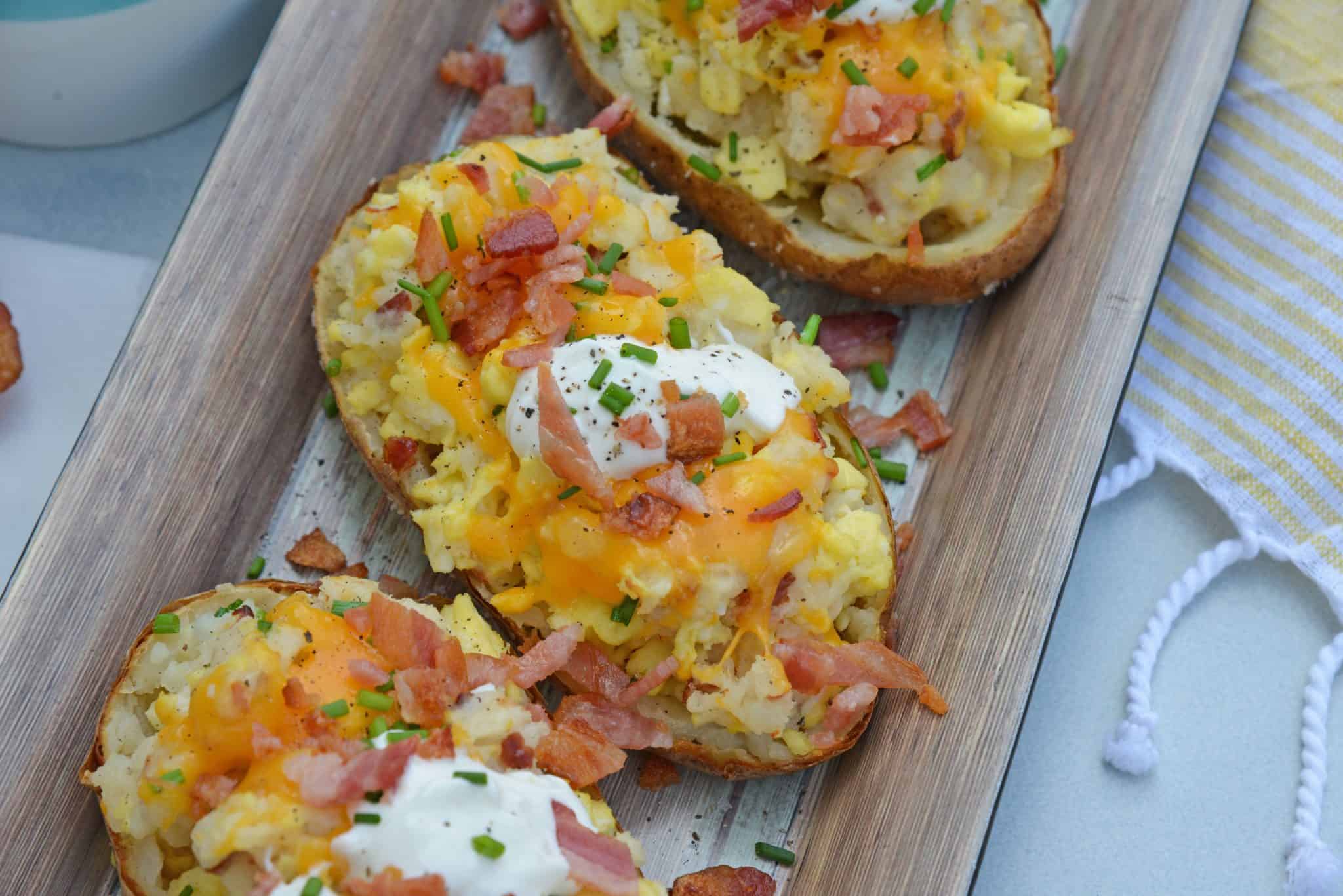 Twice Baked Breakfast Potatoes use leftover potatoes with scrambled eggs, cheddar cheese, chives, sour cream and BACON for the perfect easy breakfast recipe. #breakfastpotatoes www.savoryexperiments.com