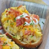 Twice Baked Breakfast Potatoes use leftover potatoes with scrambled eggs, cheddar cheese, chives, sour cream and BACON for the perfect easy breakfast recipe. #breakfastpotatoes www.savoryexperiments.com