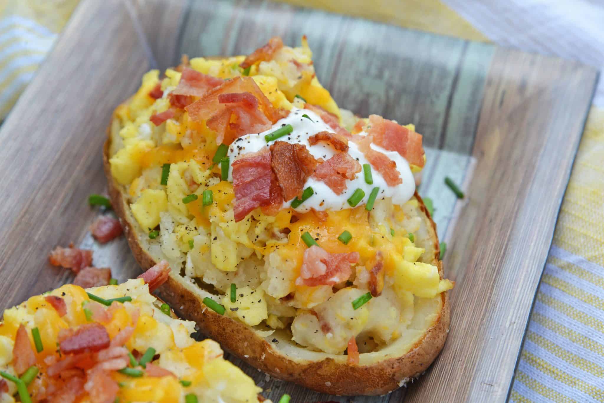 Twice Baked Breakfast Potatoes use leftover potatoes with scrambled eggs, cheddar cheese, chives, sour cream and BACON for the perfect easy breakfast recipe. #breakfastpotatoes www.savoryexperiments.com