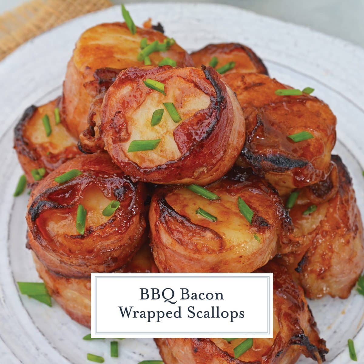 bacon wrapped scallops on a white plate  